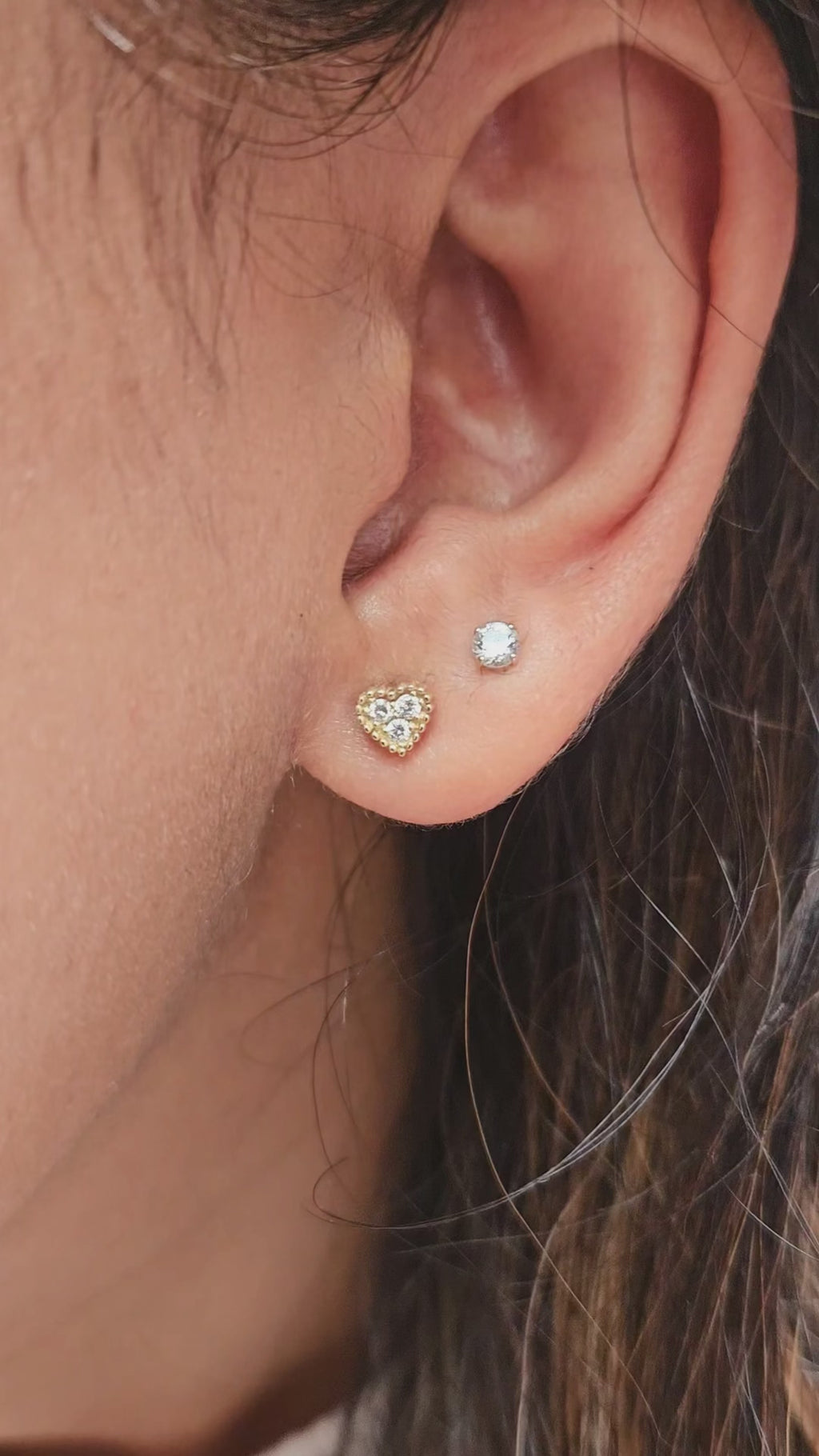 Gold heart diamond earrings on ear video