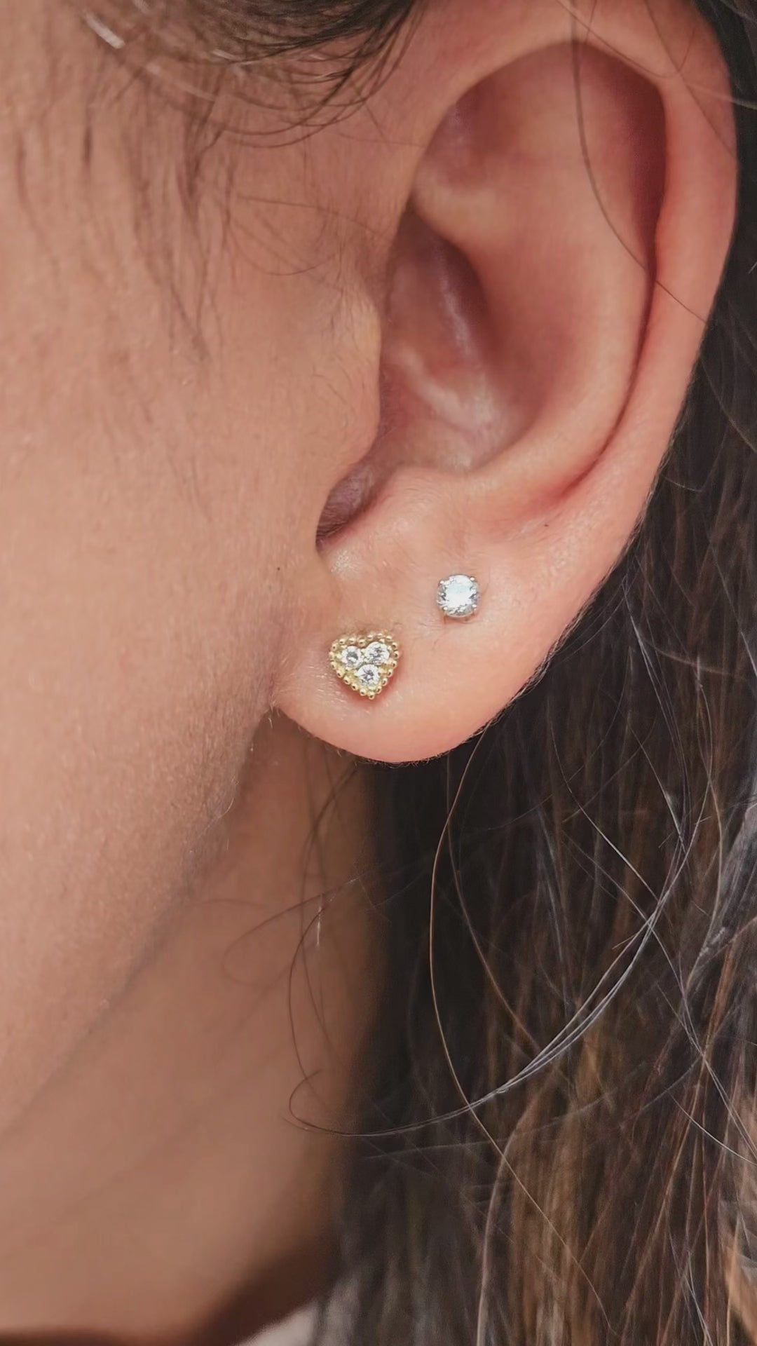Gold heart diamond earrings on ear video